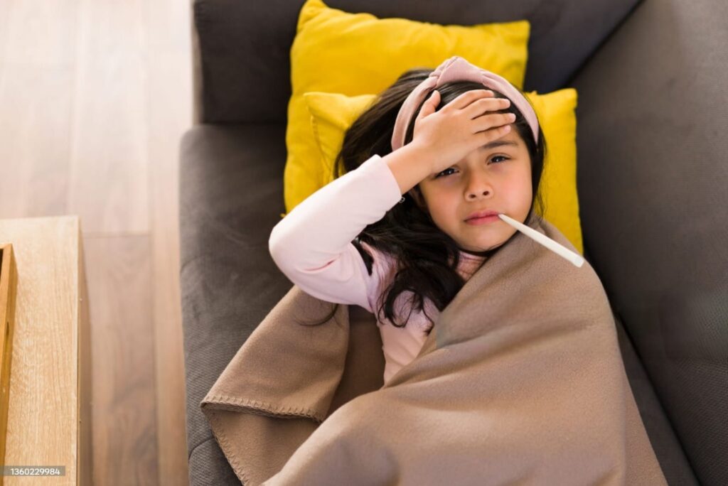 “child looking uncomfortable with high fever symptoms — fever in children warning signs”