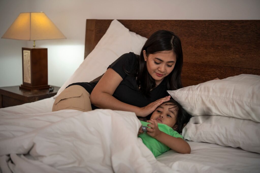 “mother caring for child with fever at home — child fever care”