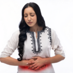 “woman experiencing abdominal pain related to women’s health issues such as PCOS thyroid and anemia”